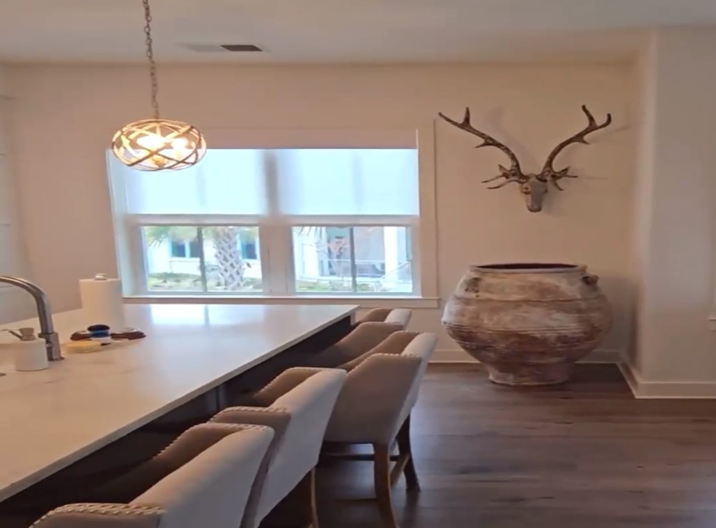 Large living area using motorization to bring up sheer shades on multiple windows